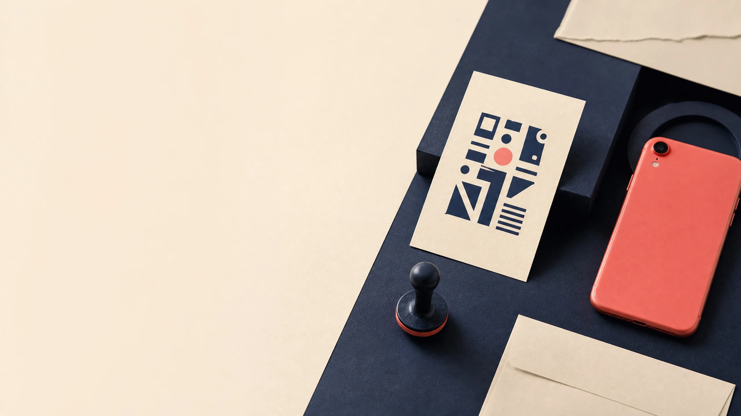 Abstract QR-inspired paper card, coral phone, and ink-navy desk objects.