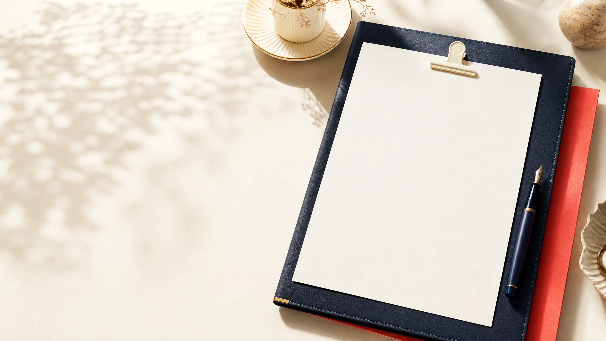 Editorial workspace with a carefully arranged resume document and warm stationery