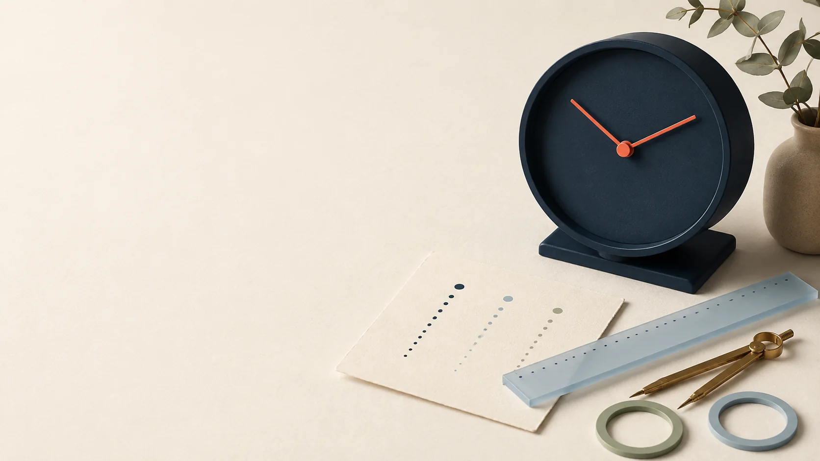 Ink navy clock, abstract timestamp cards, blue ruler, and brass stationery on an ivory desk