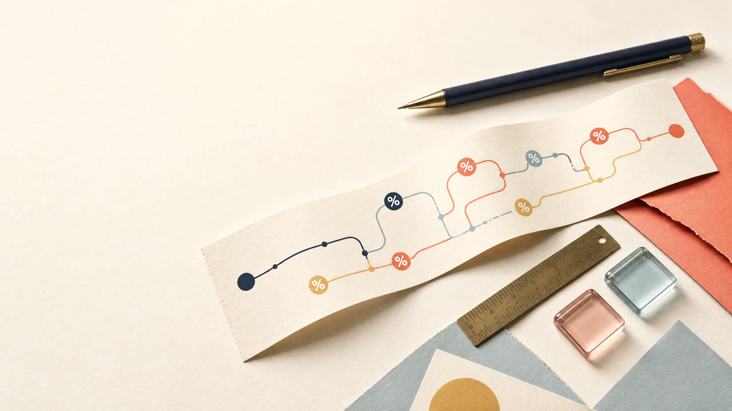 Abstract paper route lines and percent tokens arranged with stationery on an ivory desk